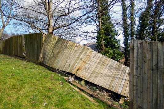 Timber fence blown down by a storm. 