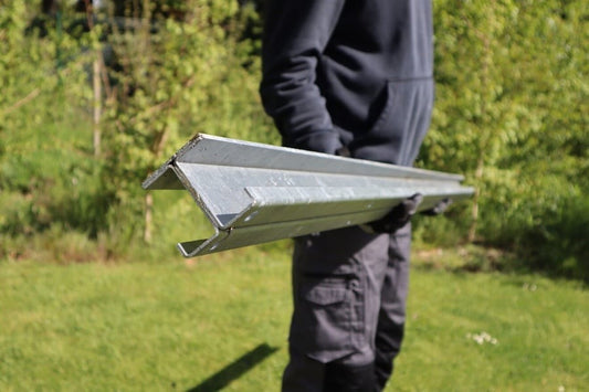 A person holding a metal DuraPost® Fence Post.