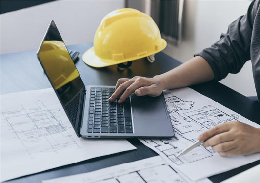 An architect using a computer to draw a design