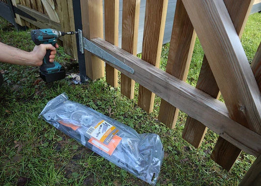 image of a GATEMATE® HEAVY TEE HINGES | 15" 375MM BZP being drilled into a gate 