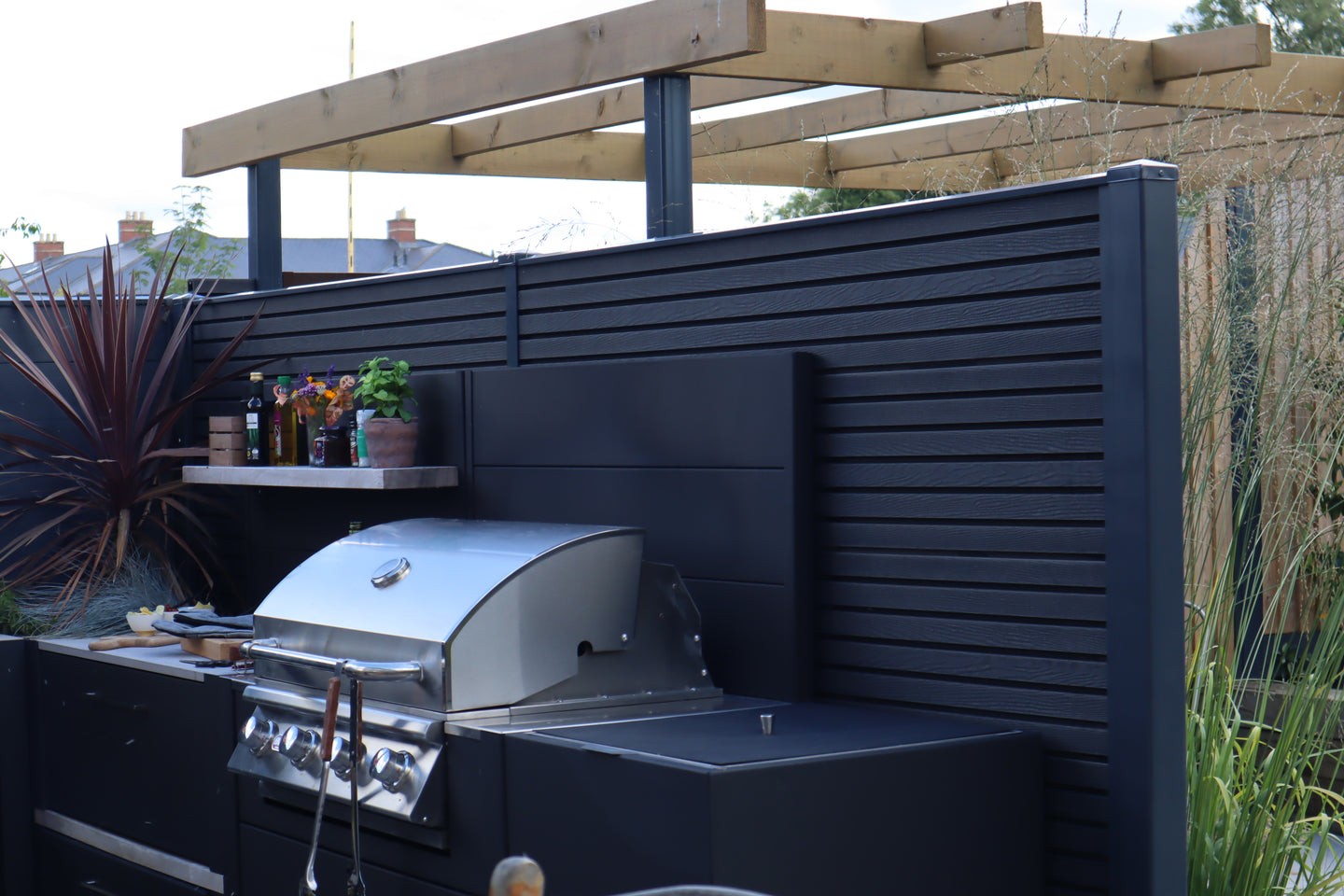 garden bbq area using Durapost Urban composite fence in anthracite grey